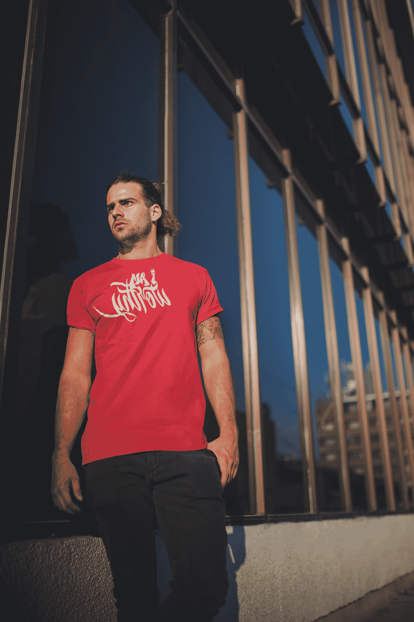 mockup-of-a-man-wearing-a-sublimated-tshirt-against-a-building-s-mirrors-a19939-min